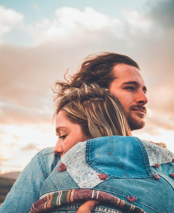 A couple hugging at golden hour