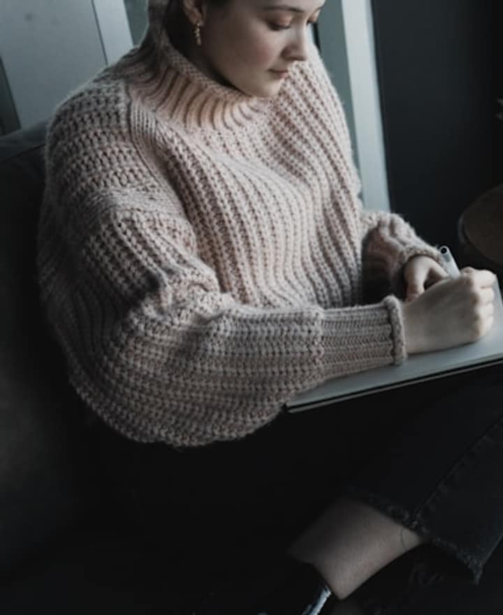 A woman reading quietly by a window