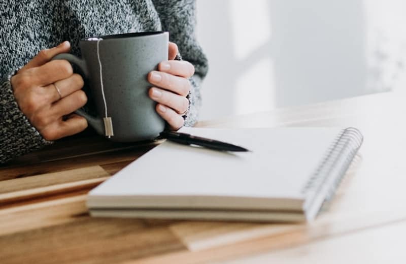 Coffee and notebooks on a calm morning desk