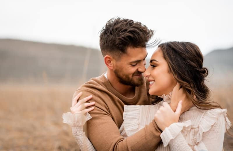 A couple embracing in a golden field